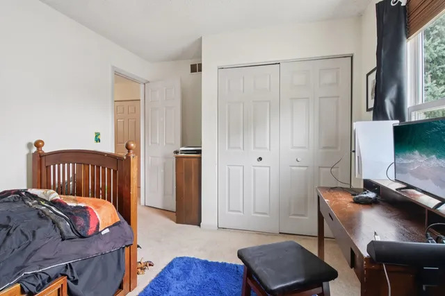 a bedroom with a bed and a chair