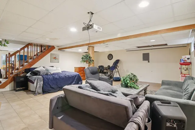 a living room with furniture and stairs