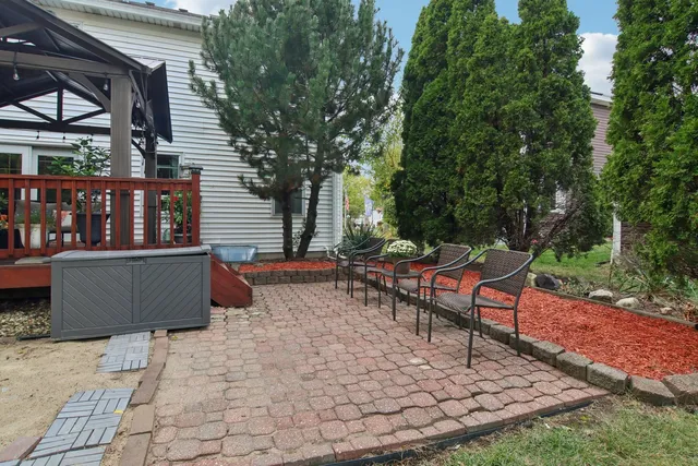 a backyard of a house with table and chairs