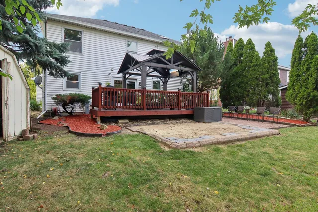 a view of a house with a yard and sitting area