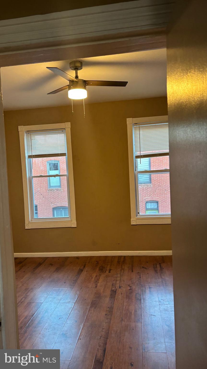 26 North Decker Avenue Baltimore, MD 21224 - Photo 11 of 14 a view of empty room with window and wooden floor