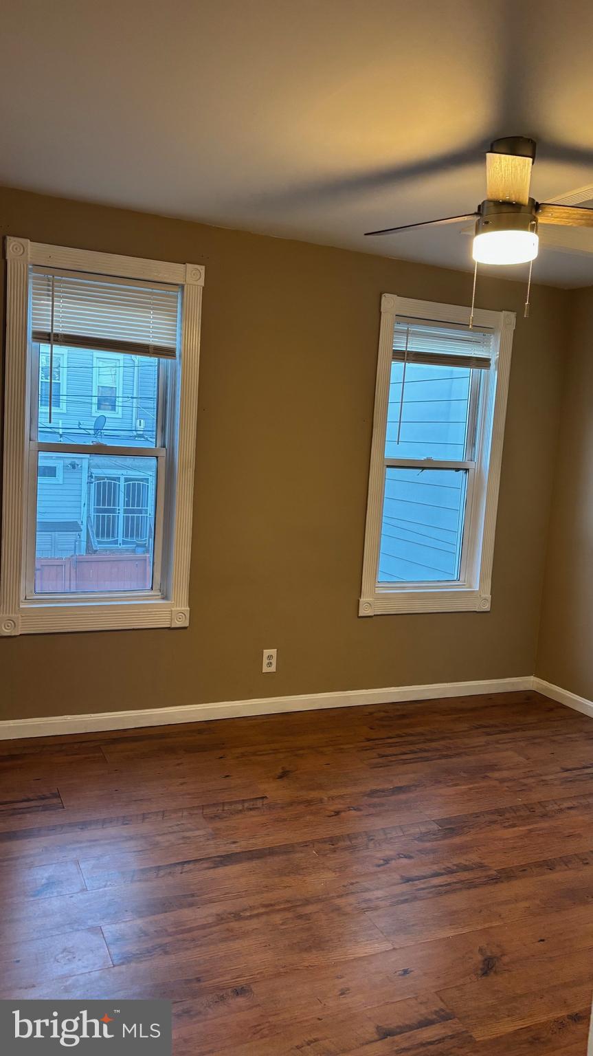 26 North Decker Avenue Baltimore, MD 21224 - Photo 12 of 14 a view of an empty room with wooden floor and a window