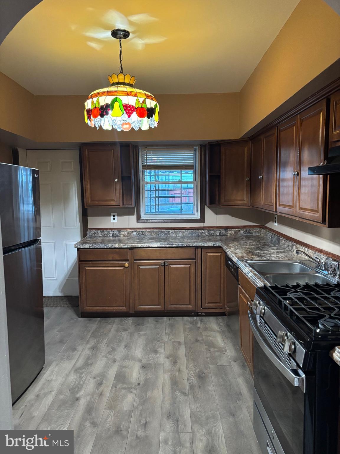 26 North Decker Avenue Baltimore, MD 21224 - Photo 3 of 14 a kitchen with granite countertop a stove and a refrigerator