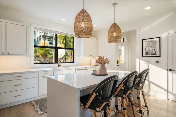 a kitchen with a table chairs and a window