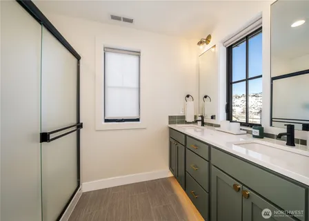 a bathroom with a double vanity sink and mirror