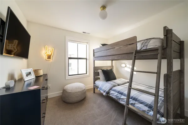 a bedroom with a bed and a flat screen tv