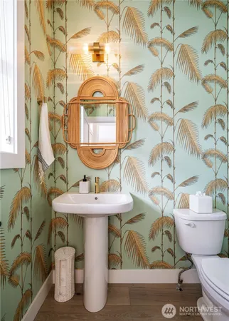 a bathroom with a toilet sink and mirror