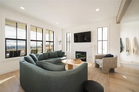 a living room with fireplace furniture and a flat screen tv