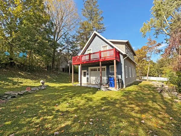 a view of a house with a yard patio and a slide