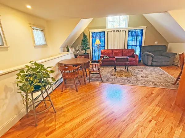 a dining table with chairs and kitchen view