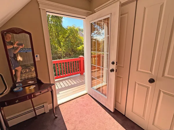 a bedroom with a bed a window and dresser