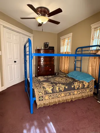 a bed sitting in a bedroom next to a window