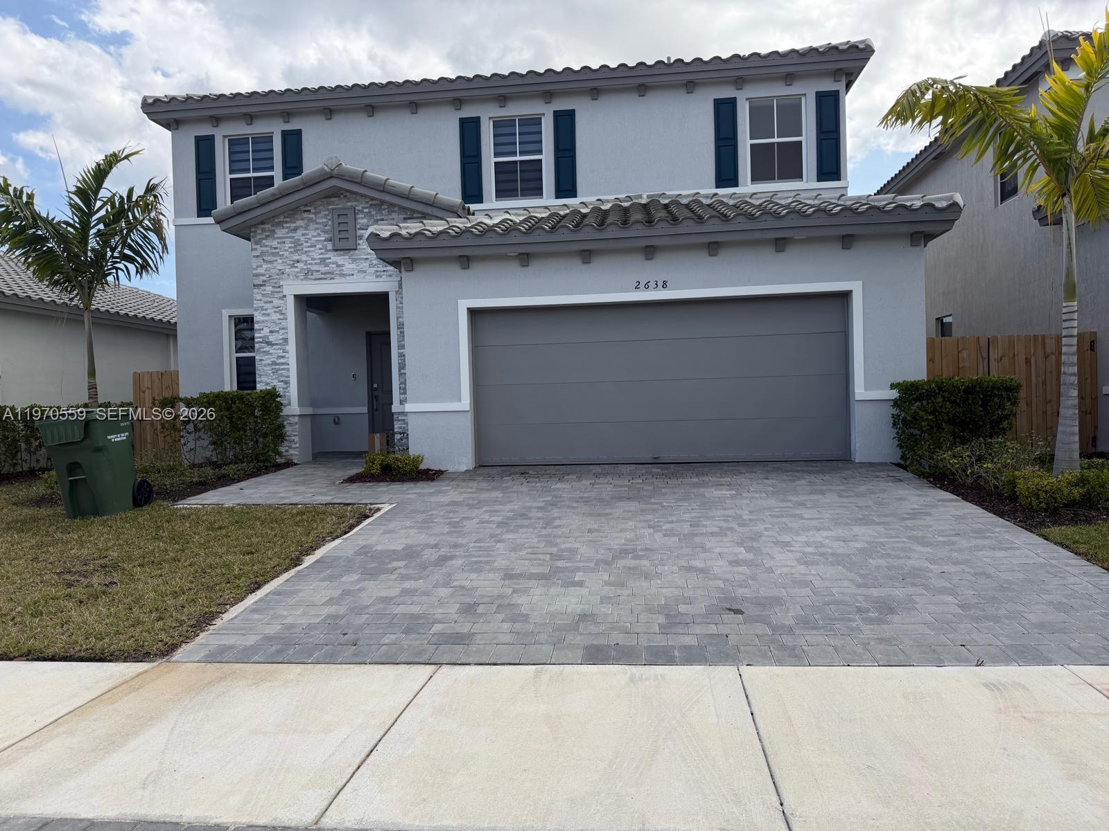 2638 Southeast 9th Street Homestead, FL 33035 - Photo 1 of 36 a front view of a house with a yard and garage