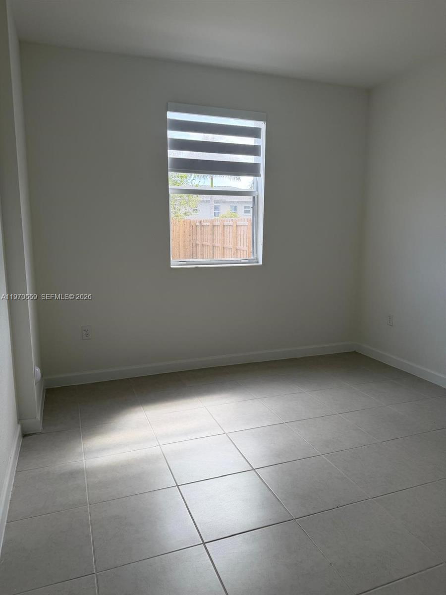 2638 Southeast 9th Street Homestead, FL 33035 - Photo 11 of 36 a view of an empty room with a window