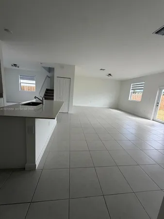 a view of a kitchen with a sink and chandelier