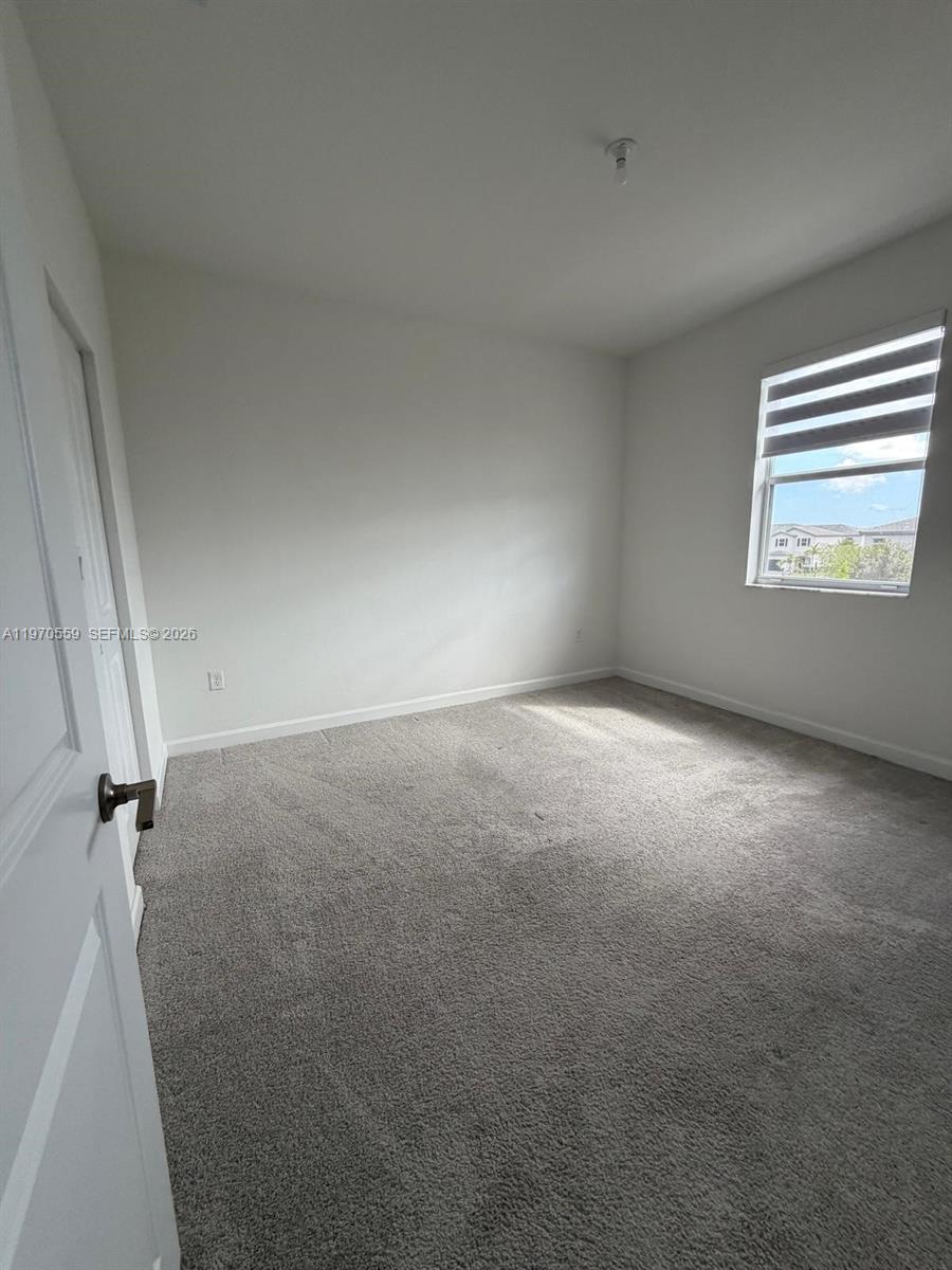2638 Southeast 9th Street Homestead, FL 33035 - Photo 16 of 36 an empty room with windows