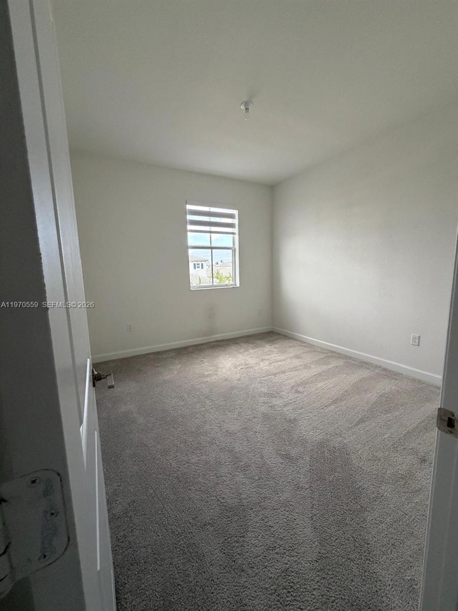 2638 Southeast 9th Street Homestead, FL 33035 - Photo 27 of 36 an empty room with windows