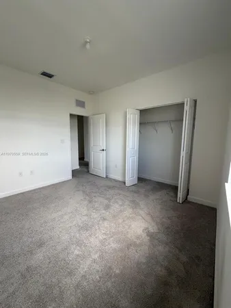 a view of an empty room and closet area