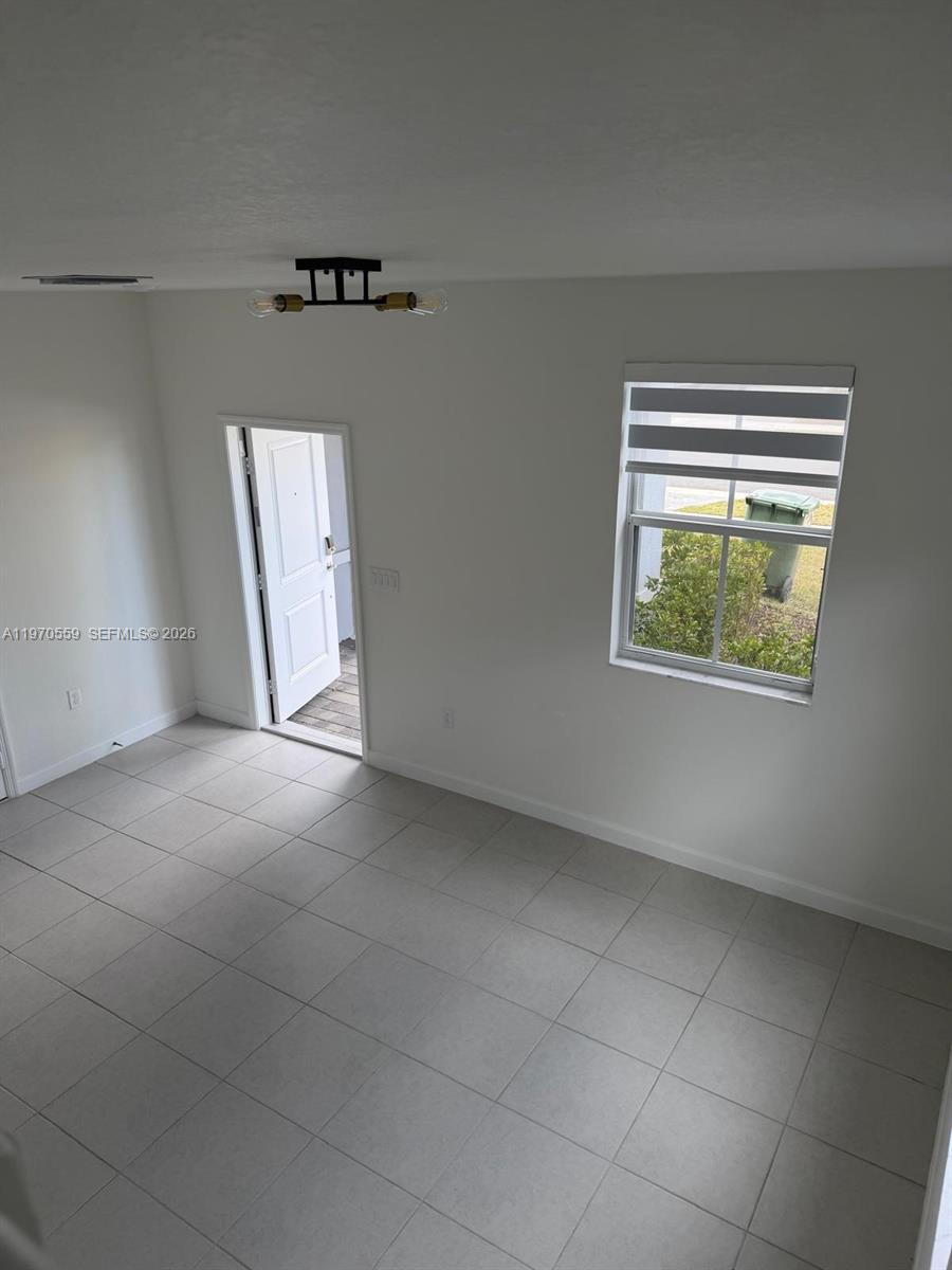 2638 Southeast 9th Street Homestead, FL 33035 - Photo 31 of 36 a view of an empty room with a window