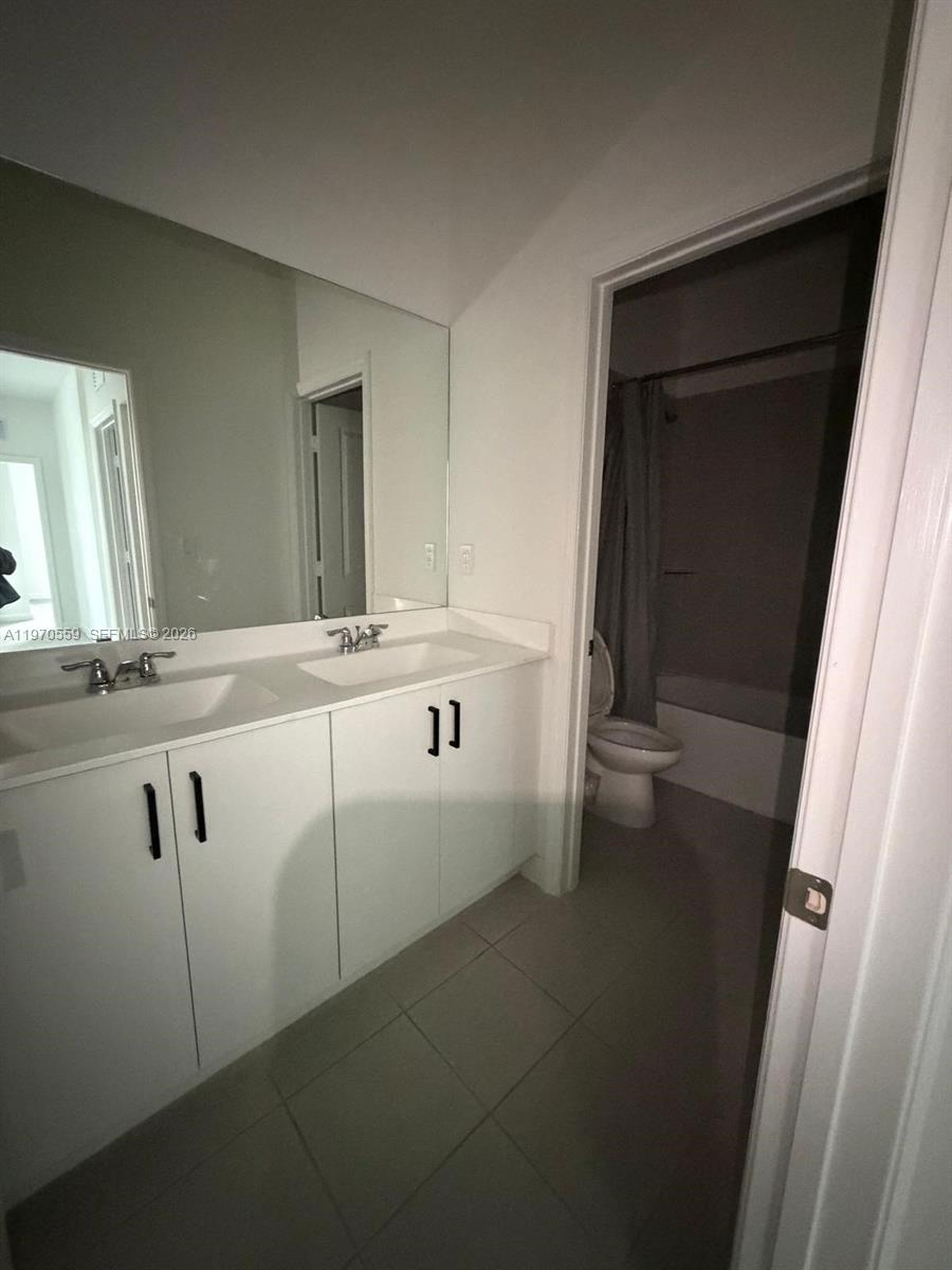 2638 Southeast 9th Street Homestead, FL 33035 - Photo 32 of 36 a bathroom with a sink and a mirror