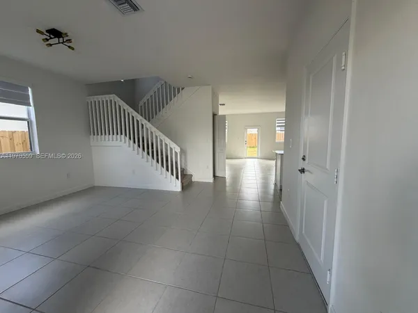 wooden floor in a hall with a window