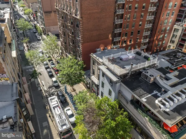an aerial view of a multi story parking building with yard and parking space