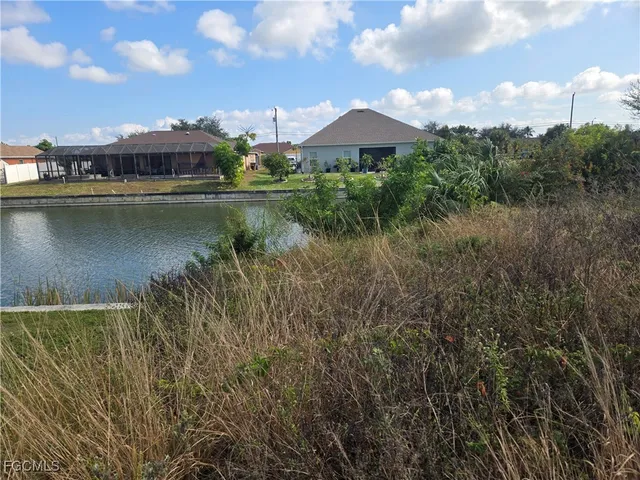 a view of a lake with a house in the background