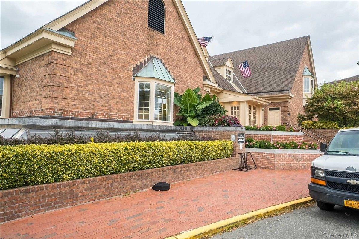 208-06 Robert Road, Unit 2 Queens, NY 11360 - Photo 17 of 26 a front view of a house with a yard and garage