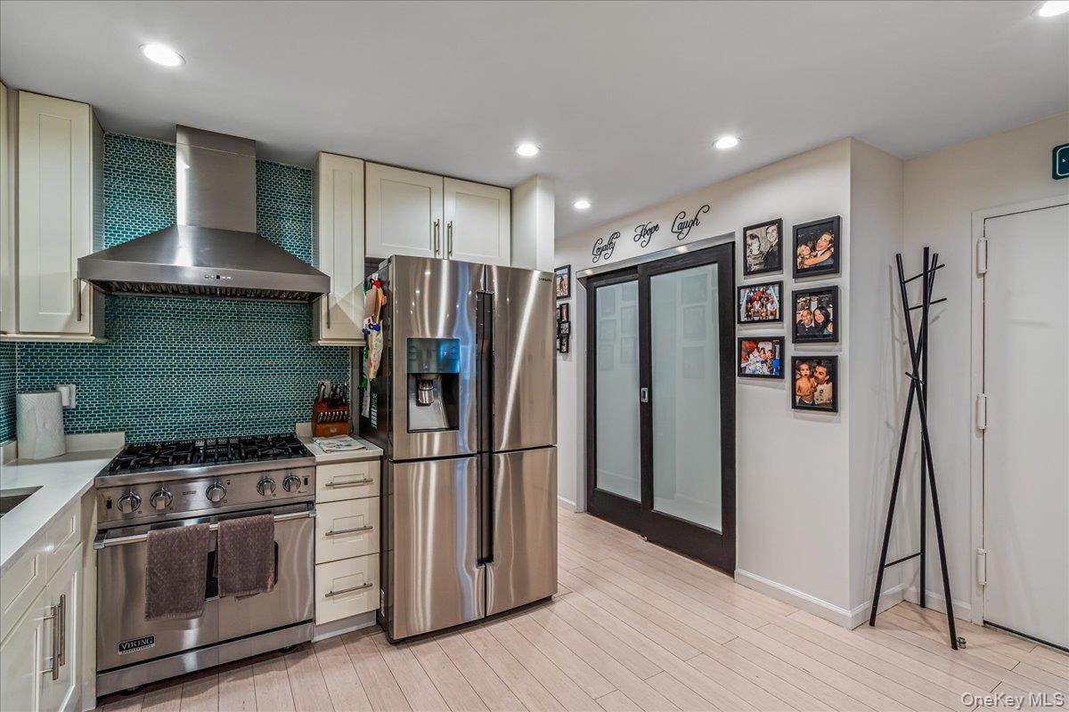 208-06 Robert Road, Unit 2 Queens, NY 11360 - Photo 9 of 26 a kitchen with a stove and a refrigerator