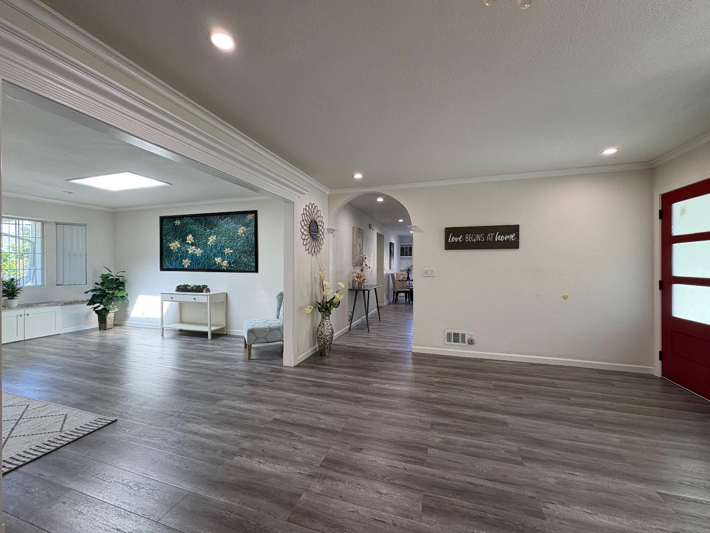 5187 Doyle Road San Jose, CA 95129 - Photo 13 of 39 a view of a livingroom with wooden floor and a ceiling fan