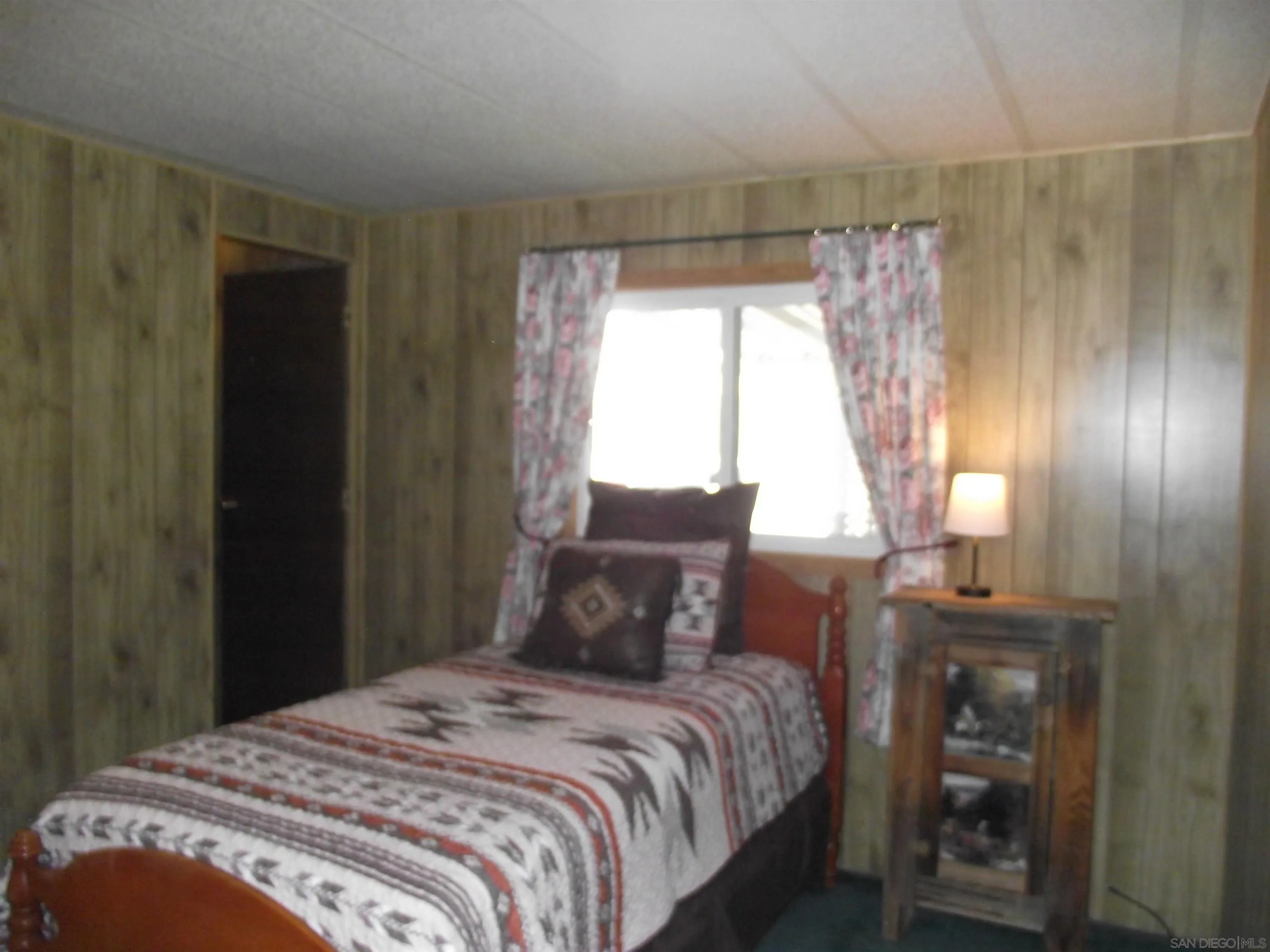 35109 Highway 79, Unit /SPC #25 Warner Springs, CA 92086 - Photo 39 of 65 a bedroom with a bed and wooden floor