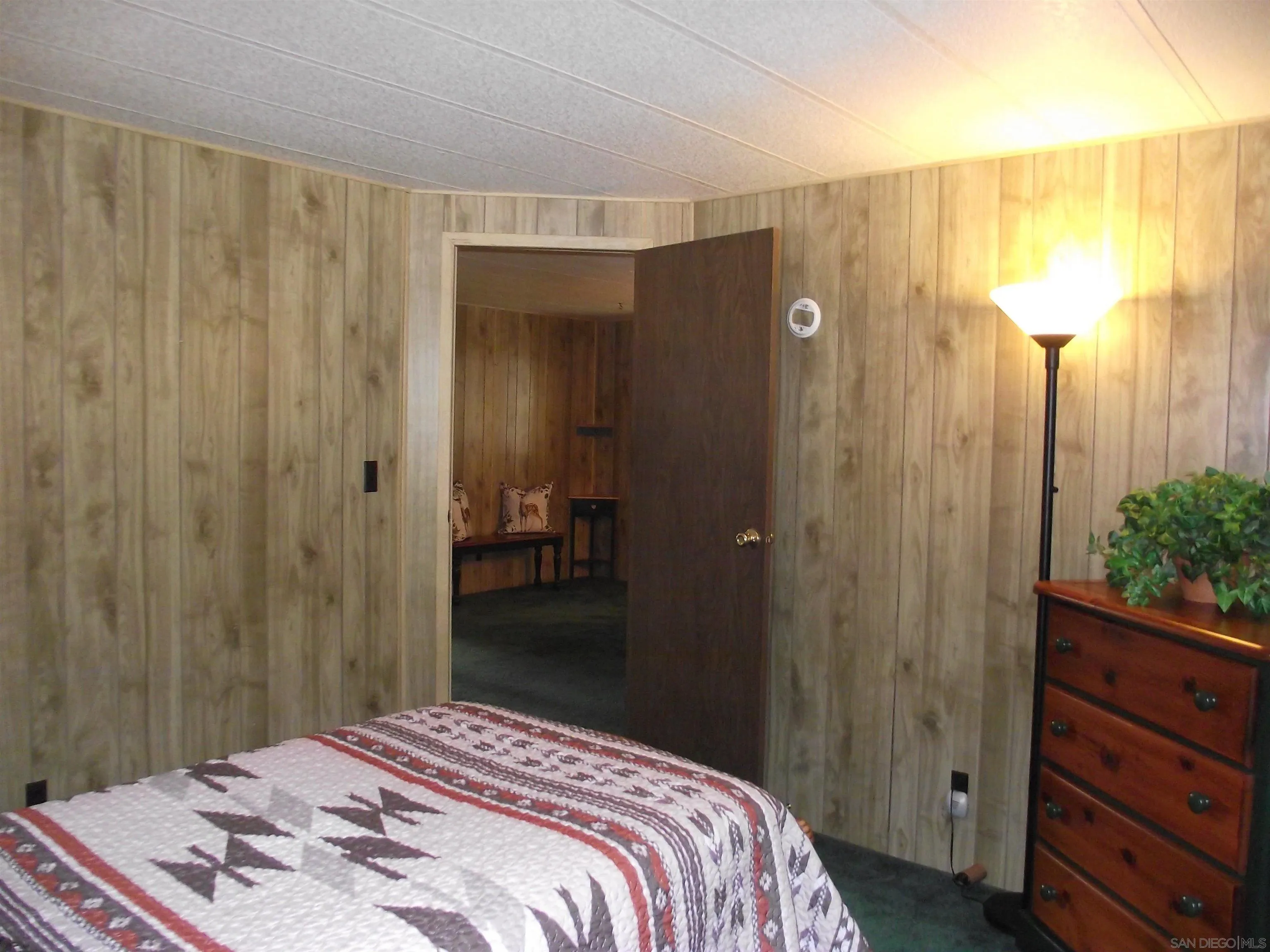 35109 Highway 79, Unit /SPC #25 Warner Springs, CA 92086 - Photo 41 of 65 a bedroom with a bed and a chandelier