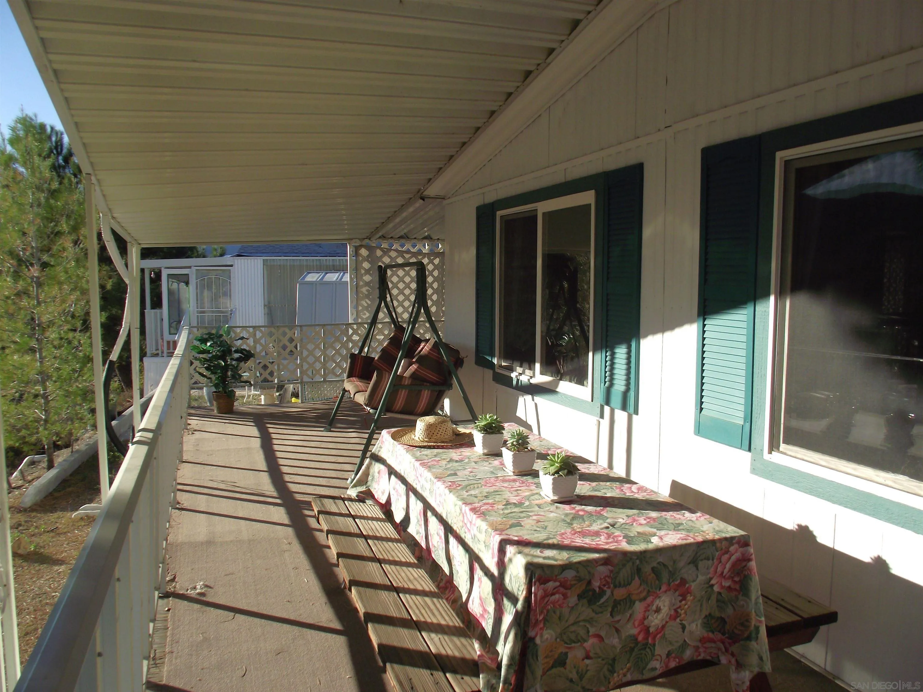 35109 Highway 79, Unit /SPC #25 Warner Springs, CA 92086 - Photo 8 of 65 a view of a patio with table and chairs a barbeque with floor to ceiling window