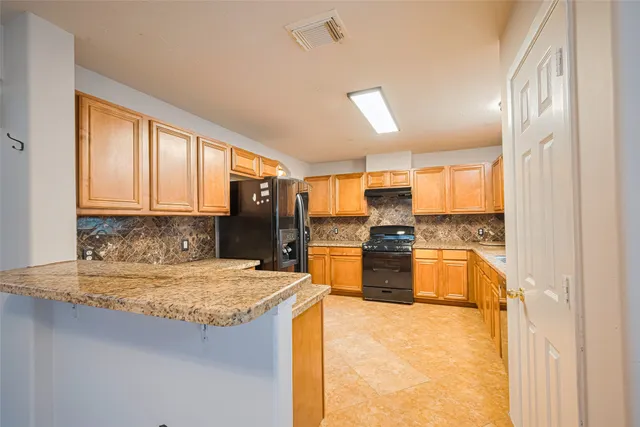 a view of an empty room with a fireplace and a window