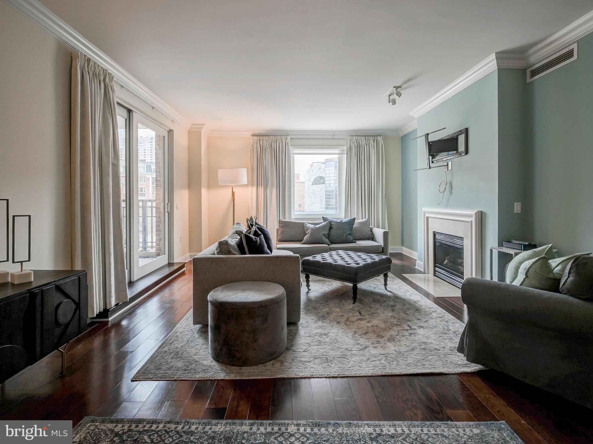 801 Key Highway, Unit 312 Baltimore, MD 21230 - Photo 14 of 45 a living room with furniture and a fireplace