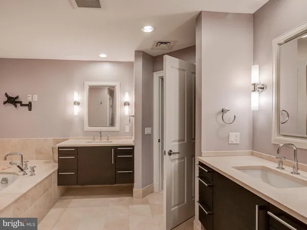 a spacious bathroom with a double vanity sink mirror double and shower