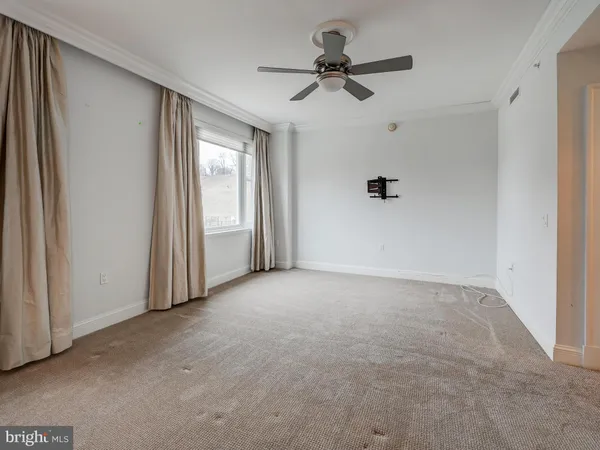 a view of a livingroom with a ceiling fan and window