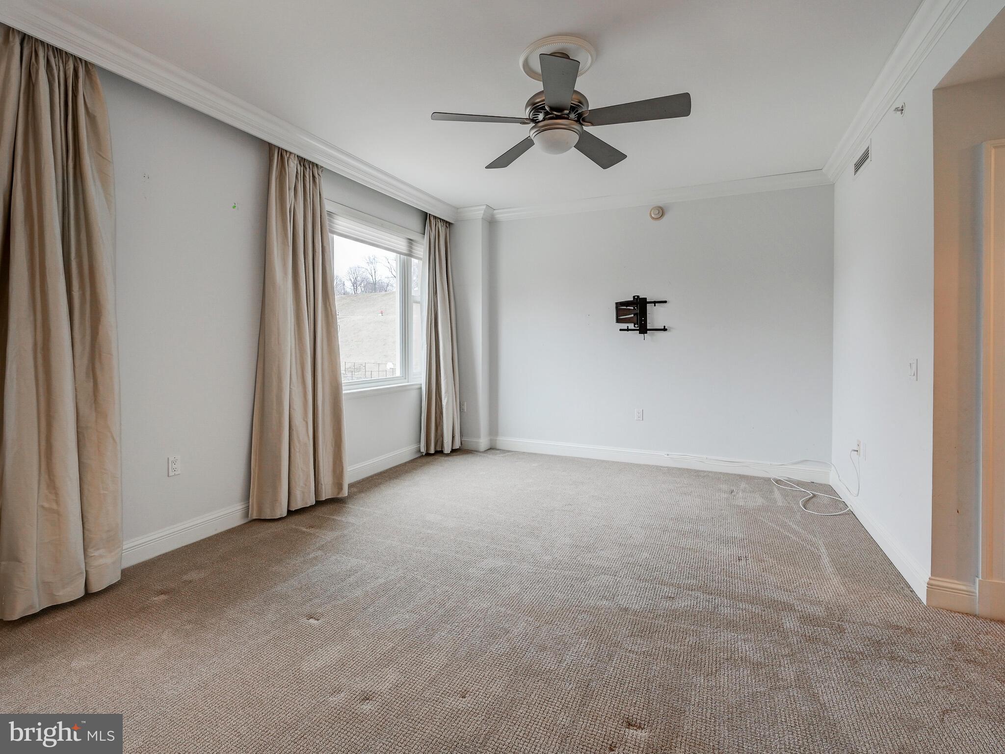 801 Key Highway, Unit 312 Baltimore, MD 21230 - Photo 29 of 45 a view of a livingroom with a ceiling fan and window