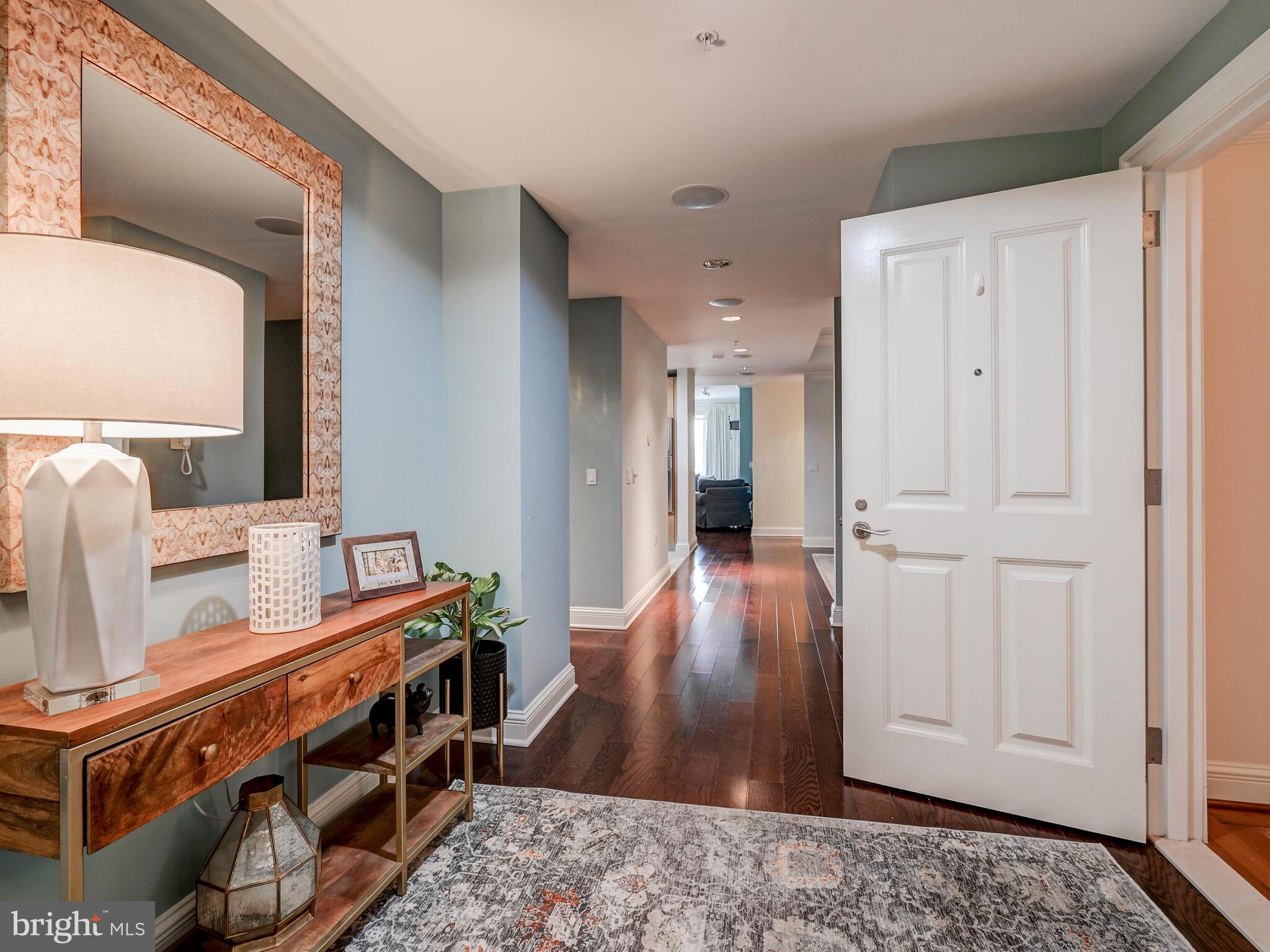 801 Key Highway, Unit 312 Baltimore, MD 21230 - Photo 3 of 45 a view of a hallway with wooden floor and bathroom