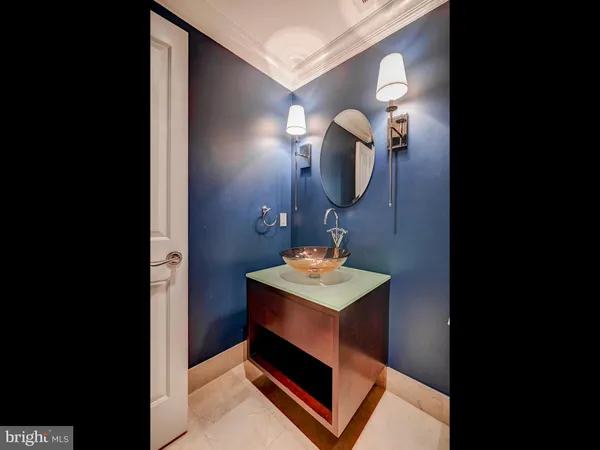 a bathroom with a sink a light fixture and a mirror