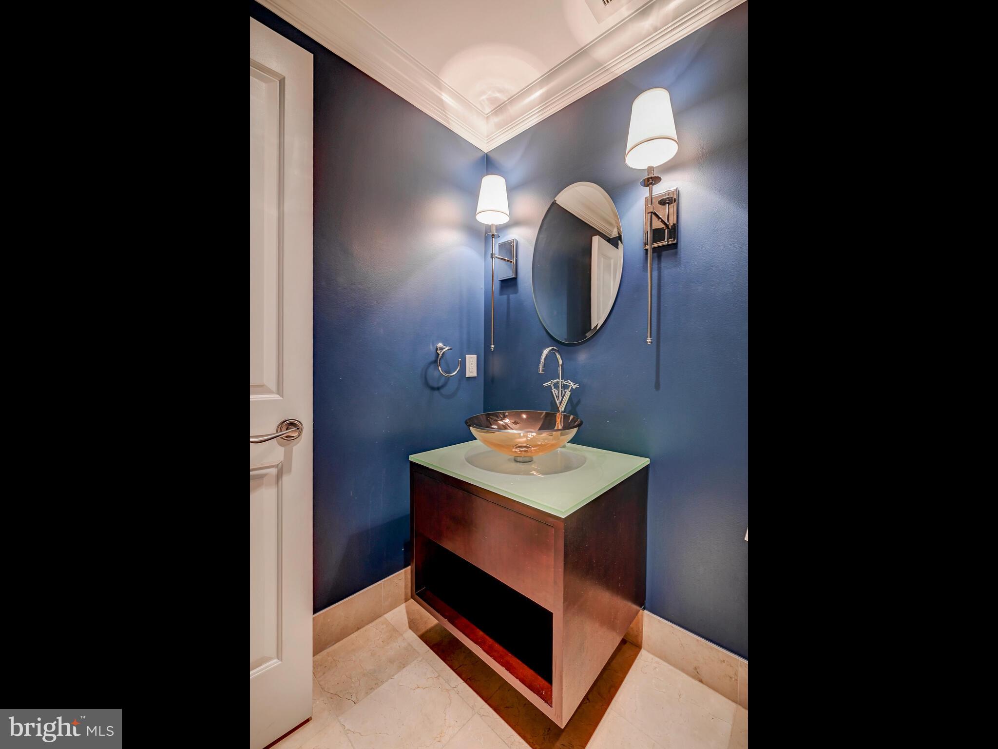 801 Key Highway, Unit 312 Baltimore, MD 21230 - Photo 34 of 45 a bathroom with a sink a light fixture and a mirror
