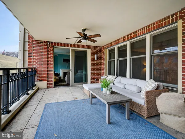 a balcony with furniture and wooden floor