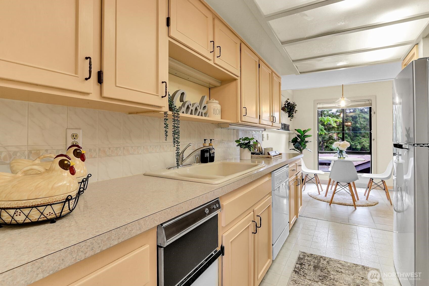 1541 Northeast 143rd Street, Unit H5 Seattle, WA 98125 - Photo 12 of 31 a kitchen with a white cabinets and chairs