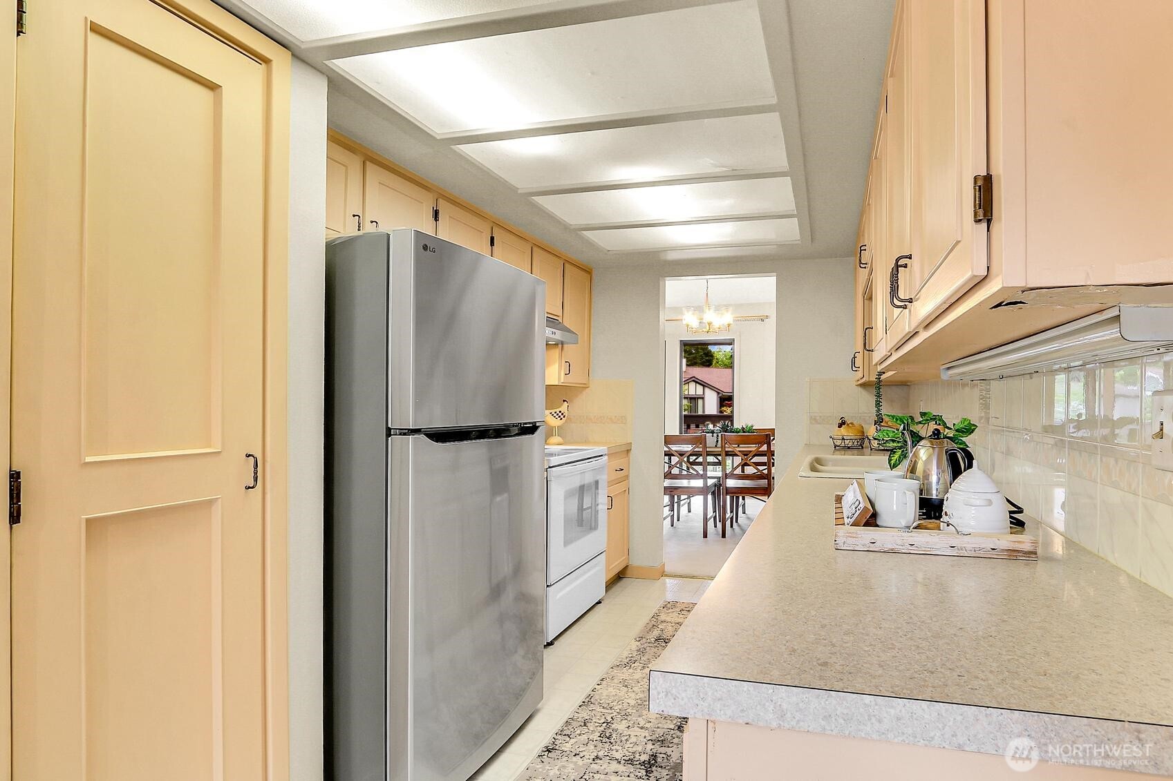 1541 Northeast 143rd Street, Unit H5 Seattle, WA 98125 - Photo 13 of 31 a kitchen with stainless steel appliances granite countertop a refrigerator and a sink