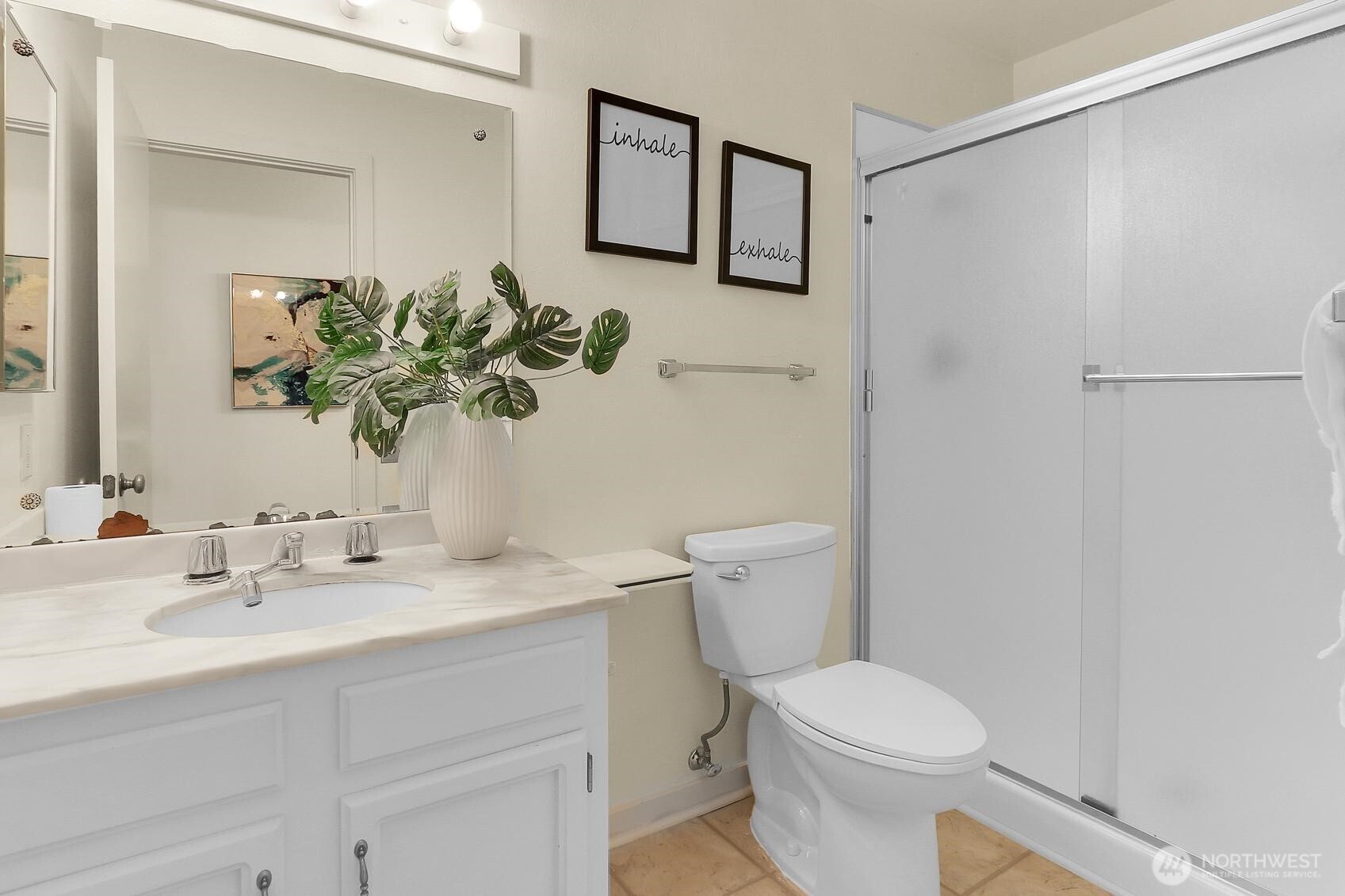 1541 Northeast 143rd Street, Unit H5 Seattle, WA 98125 - Photo 17 of 31 a bathroom with a sink a toilet and a mirror