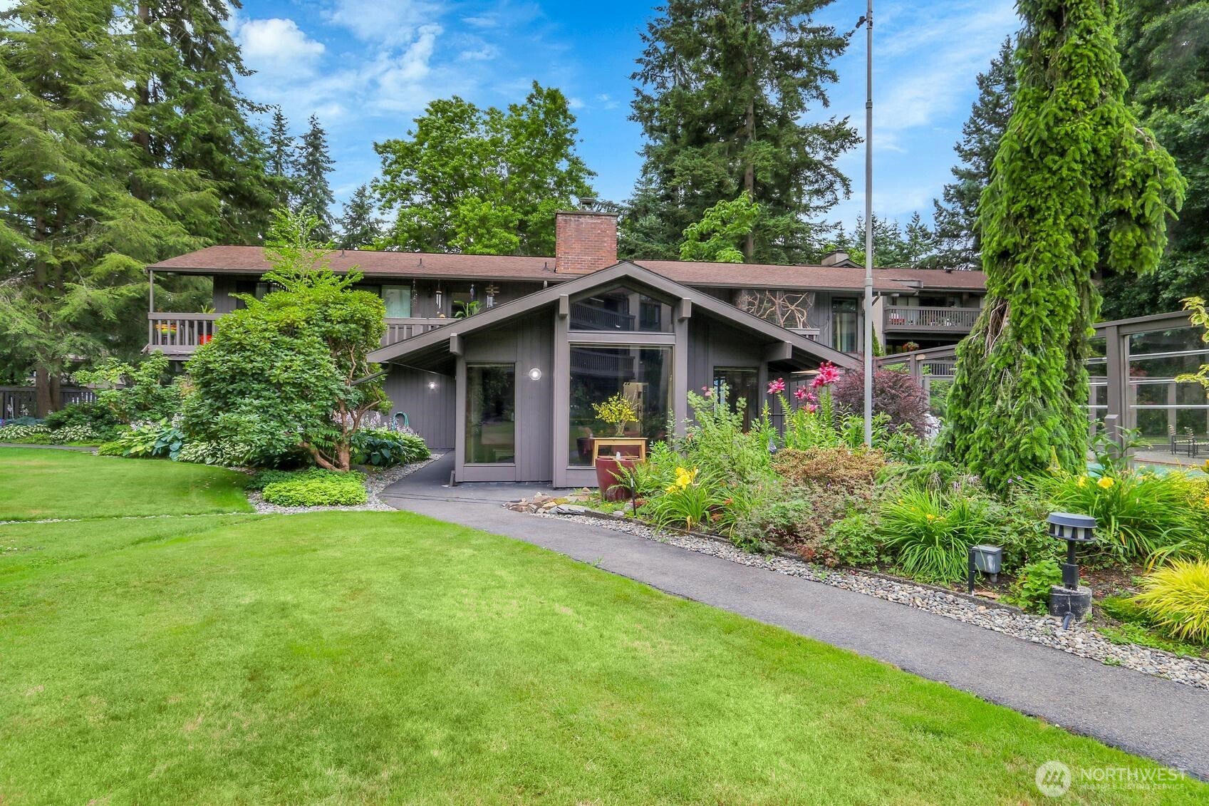 1541 Northeast 143rd Street, Unit H5 Seattle, WA 98125 - Photo 26 of 31 a front view of a house with a yard