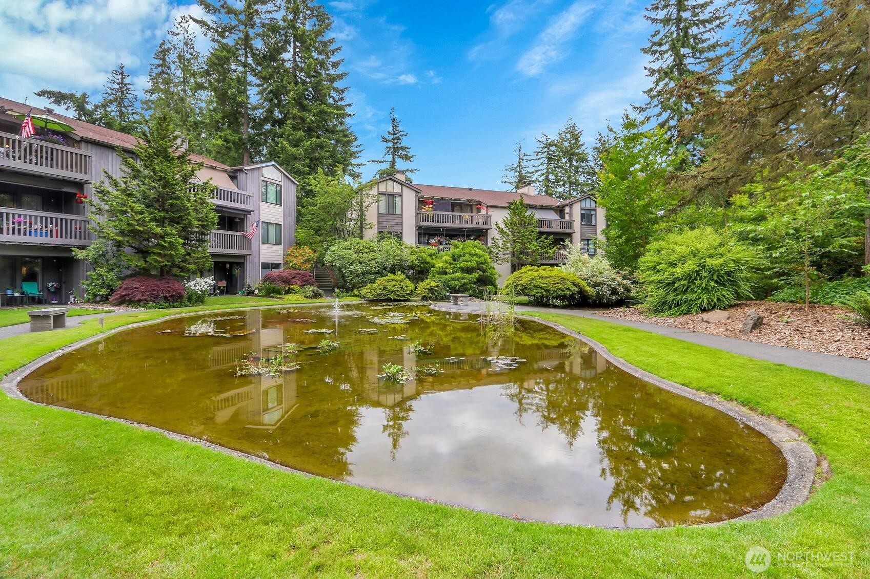1541 Northeast 143rd Street, Unit H5 Seattle, WA 98125 - Photo 30 of 31 a view of a swimming pool with a garden
