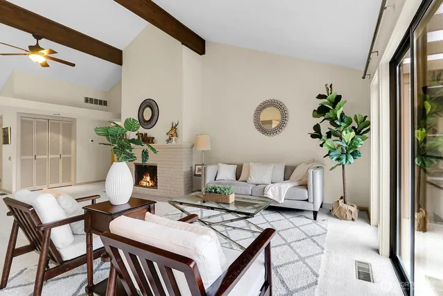 a view of a dining room with furniture and a potted plant