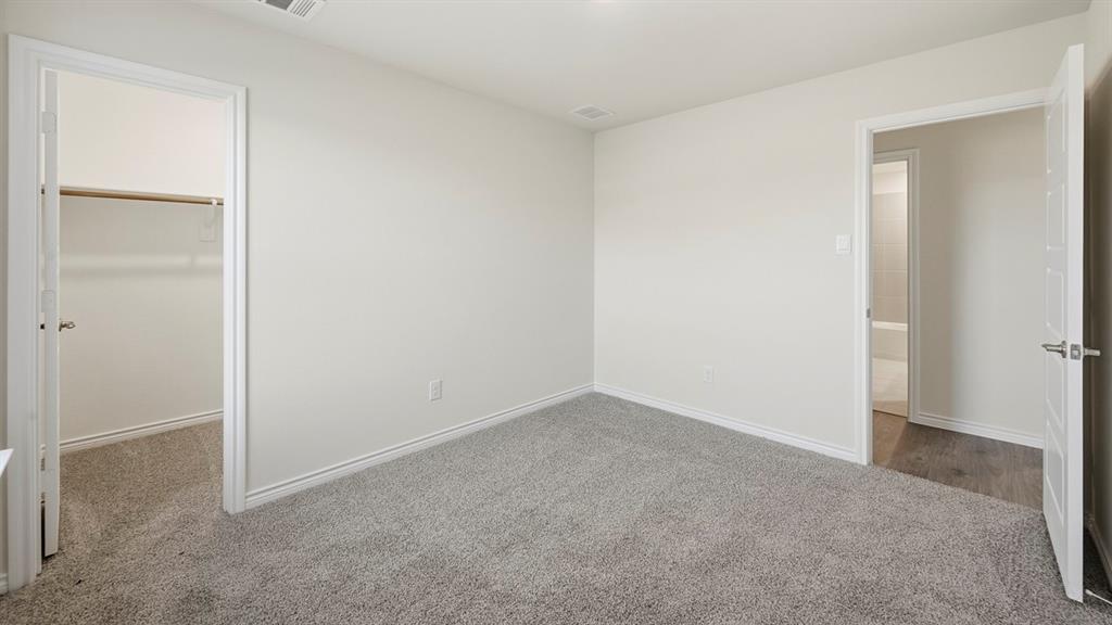 419 Epiphany Lane Lavon, TX 75166 - Photo 25 of 31 Neutral-toned room featuring light gray carpeting, white baseboards, and a white ceiling with a visible air vent