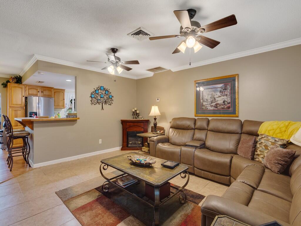 3118 Old Edwards Road Fort Pierce, FL 34981 - Photo 11 of 35 a living room with furniture a chandelier and a window